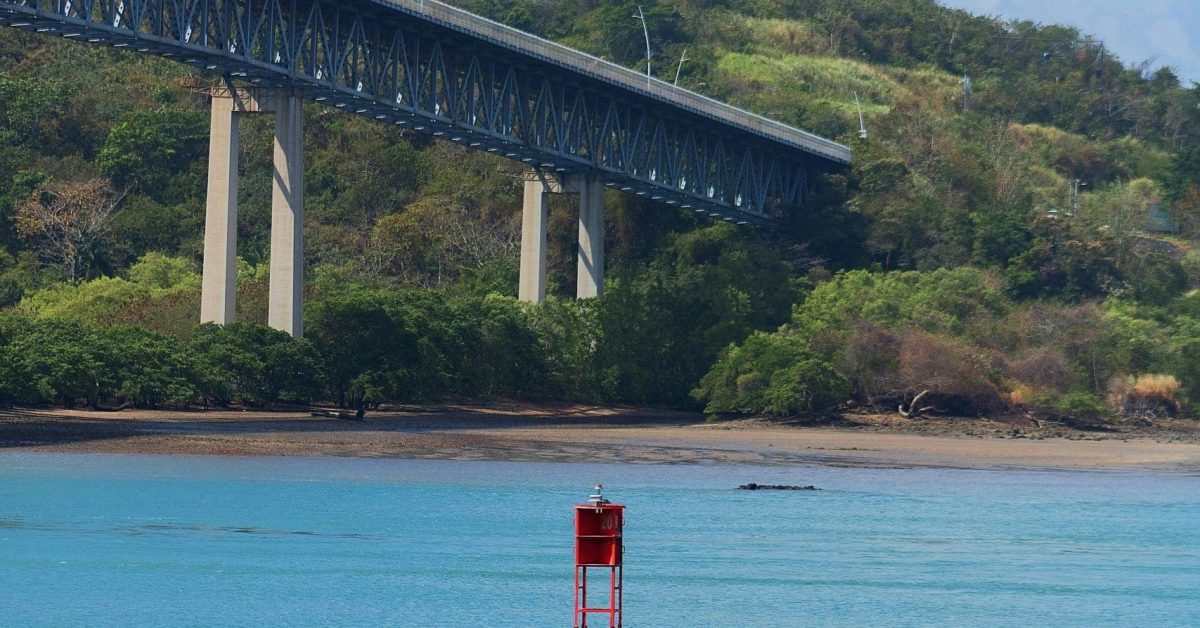 Scenic view of a buoy in Panama Canal with a bridge in the background.
