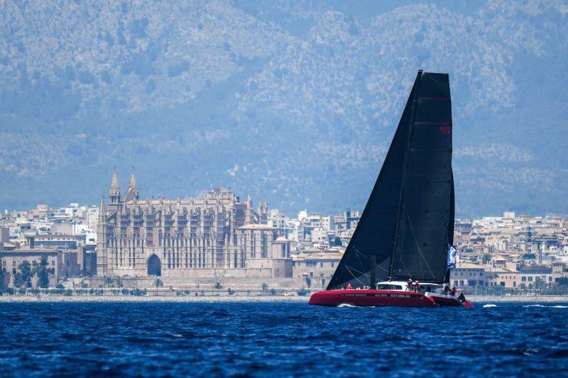 Superyacht racing off Palma with the cathedral behind