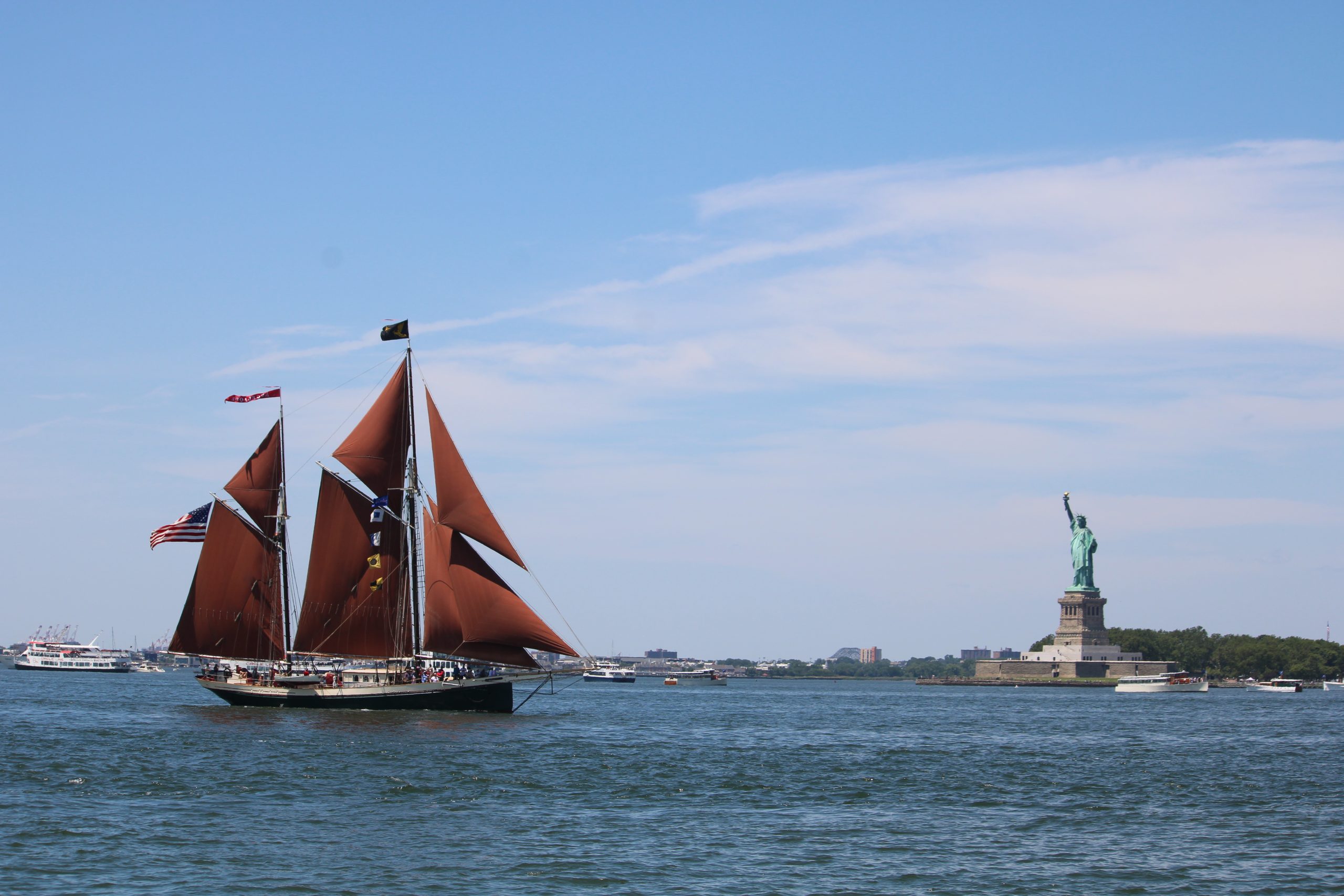 Schooner sailing in New York Harbor near the Statue of Liberty