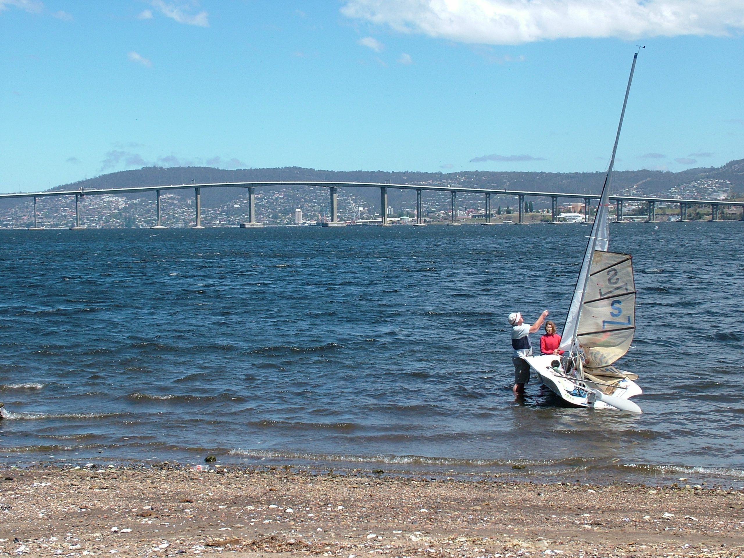 Sailing dinghy on the River Derwent below the Tasman Bridge, Hobart