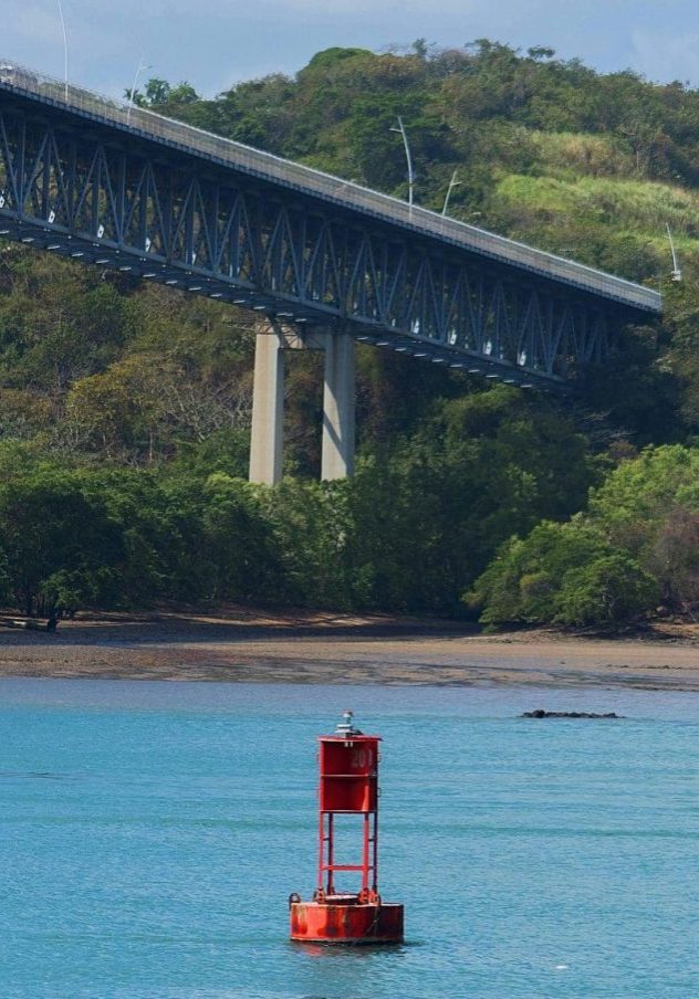 Scenic view of a buoy in Panama Canal with a bridge in the background.